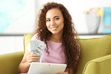 woman with tablet and money watching Netflix