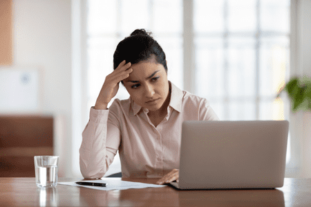 worried woman on laptop