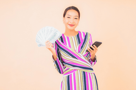 woman with cash and phone