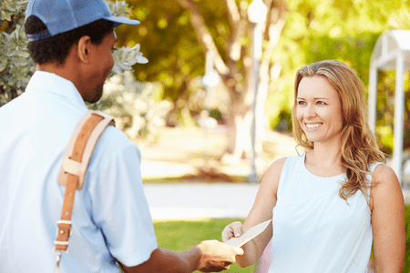 lady with envelope stuffer job handing envelope to mailman