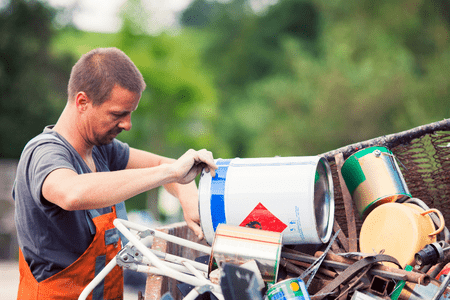 man with pile of scrap metal at nearest scrap yard