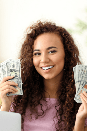 woman holding cash working from home