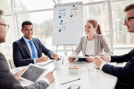 4 person investment management team sitting at desk