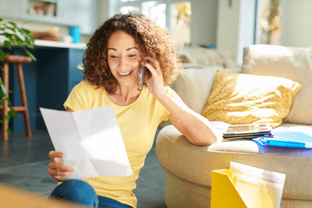 lady with phone bill and cellphone