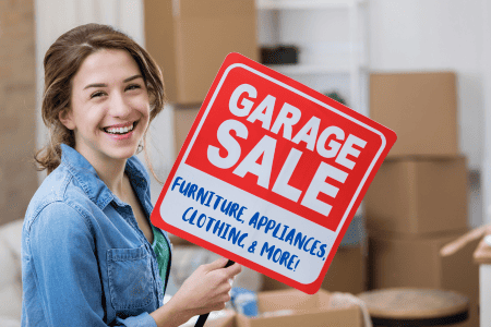 woman holding garage sale ad