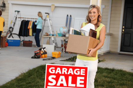 woman holding a box in a garage sale