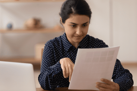 woman reading laws on how to start a private home care business