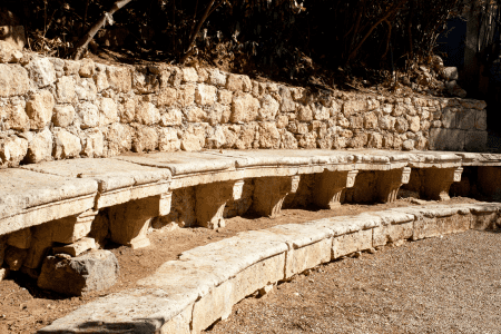 rock bench on hillside garden