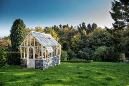 steep hillside landscaping with greenhouse deck