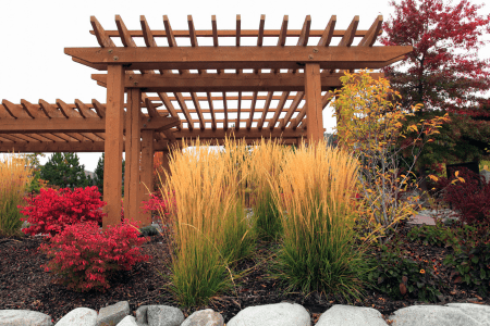 steep hillside landscaping with pergola