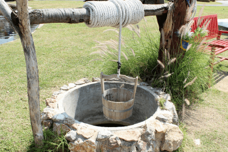 water well in sloped back yard landscaping