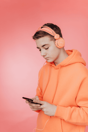 boy with headphones using cellphone