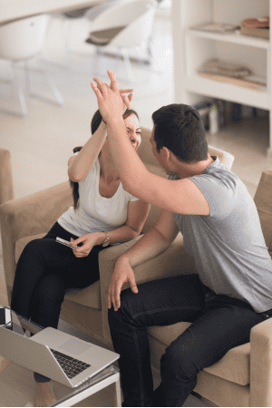 couple with laptop happy about the 15 day affiliate marketing challenge