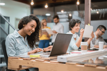 happy woman with laptop earning amazon gift card 15