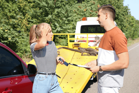 tow truck serviceman talking to lady