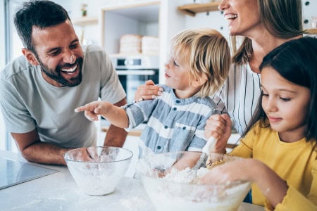family smiling together and cooking