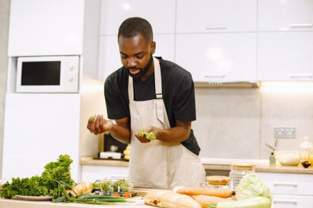 man cooking cheap meal for 1