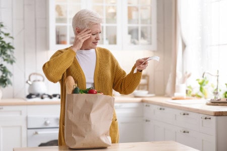 older woman upset by grocery bill