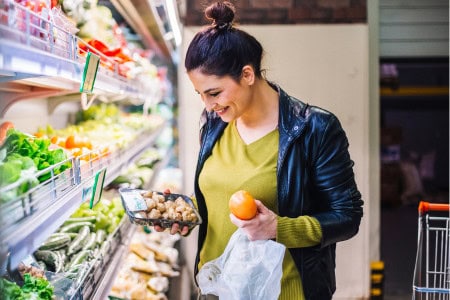 woman grocery shopping for easy cheap meals for large family