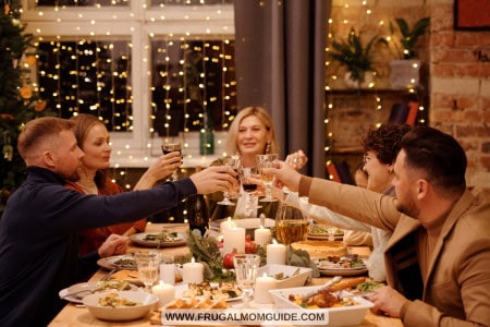 family of six having dinner and toasting