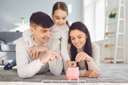 family of 3 putting money in piggy bank