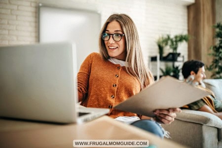 lady working with laptop with man on sofa in background