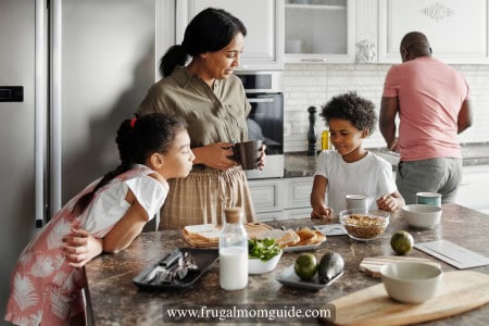family with 2 young kids cooking