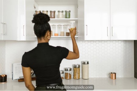 lady looking in kitchen cabinet