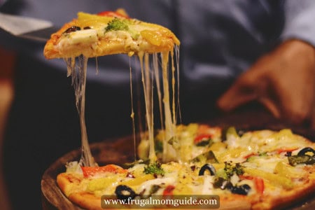 man lifting pizza slice