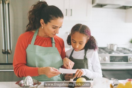 woman and young girl reading a monthly meal planning printable
